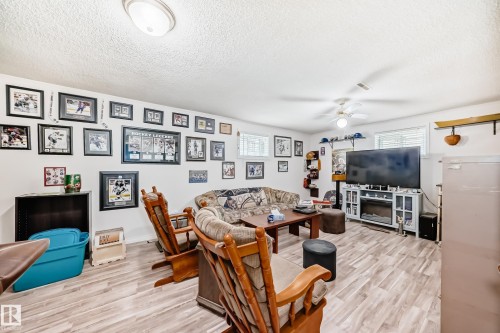 Spacious room featuring light wood-finish flooring and white walls - 4006 115 Avenue, Edmonton, AB 