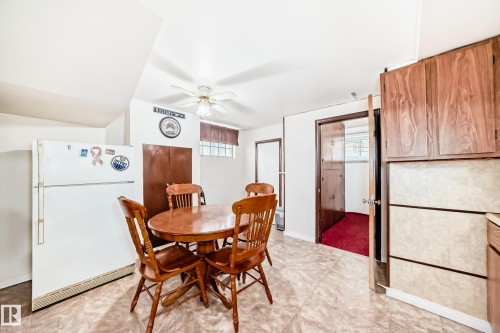Kitchenette featuring tile flooring, ceiling fan, and wood-finish cabinetry - 4006 115 Avenue, Edmonton, AB 