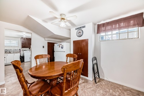 Open-concept dining area featuring tiled flooring, a ceiling fan, and painted white walls - 4006 115 Avenue, Edmonton, AB 