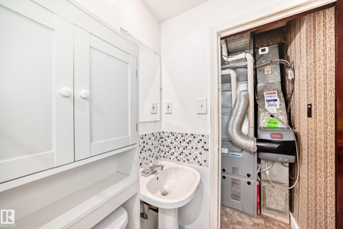 White pedestal sink with a mosaic tile backsplash - 4006 115 Avenue, Edmonton, AB 