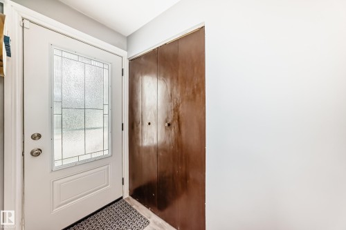 White entry door with decorative glass paneling and satin nickel hardware - 4006 115 Avenue, Edmonton, AB 