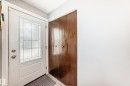 White entry door with decorative glass paneling and satin nickel hardware - 4006 115 Avenue, Edmonton, AB 