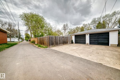 Detached two-car garage with white siding and black garage doors - 4006 115 Avenue, Edmonton, AB 