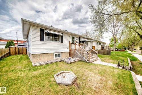 White siding exterior with a stone foundation accent - 4006 115 Avenue, Edmonton, AB 