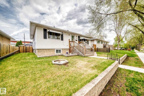 Exterior featuring white horizontal siding and a stone-clad foundation - 4006 115 Avenue, Edmonton, AB 