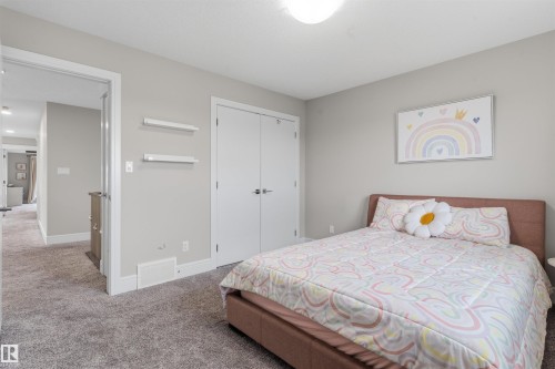 Carpeted room featuring light gray walls, white trim, and a flush-mount ceiling light fixture - 3312 11 Avenue, Edmonton, AB - Indoor Photo Showing Bedroom