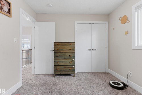 Plush carpet flooring, white trim, and neutral wall paint define this room - 3312 11 Avenue, Edmonton, AB - Indoor
