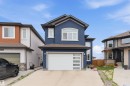 Contemporary two-story exterior featuring a deep blue stucco finish, dark brown roofing, and white trim accents - 3312 11 Avenue, Edmonton, AB  - Outdoor With Facade 