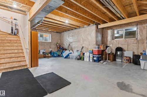 Spacious unfinished basement featuring exposed wood joists and concrete flooring - 3312 11 Avenue, Edmonton, AB - Indoor Photo Showing Basement