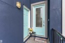 Entryway featuring a light blue door with glass panels and a chrome handle, complemented by an overhead wall sconce - 3312 11 Avenue, Edmonton, AB  - Outdoor With Exterior 