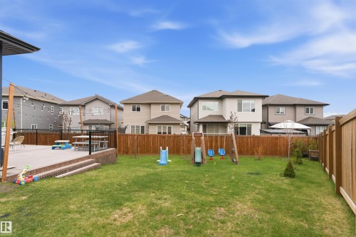 Expansive backyard featuring a manicured lawn, a raised concrete patio, and a privacy fence - 3312 11 Avenue, Edmonton, AB - Outdoor With Deck Patio Veranda With Backyard With Exterior