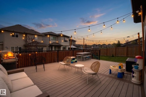 Spacious composite deck featuring string lighting, a privacy fence, and a green lawn area - 3312 11 Avenue, Edmonton, AB - Outdoor With Deck Patio Veranda With Exterior