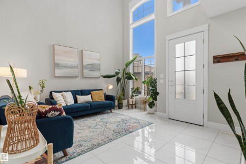 Two-story living area featuring large format white tile flooring and high ceilings - 3312 11 Avenue, Edmonton, AB - Indoor