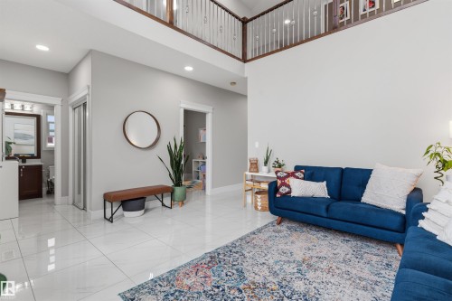 Vaulted ceiling with an open upstairs railing featuring dark wood and white balusters - 3312 11 Avenue, Edmonton, AB - Indoor