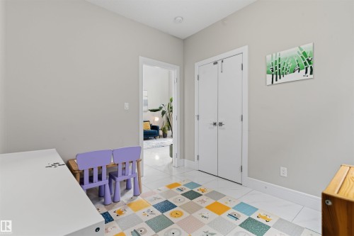 Interior space featuring light gray walls, white trim, and polished white tile flooring - 3312 11 Avenue, Edmonton, AB - Indoor Photo Showing Other Room