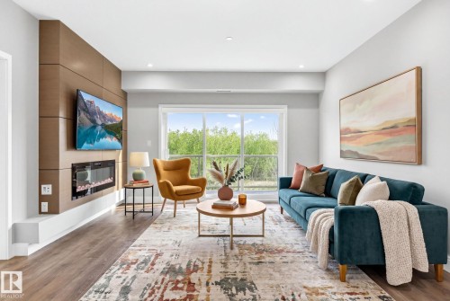 207 7463 May Common, Edmonton, AB - Indoor Photo Showing Living Room With Fireplace