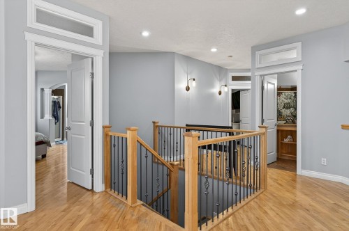 Upper-level hallway featuring wood-finish flooring, light grey painted walls, recessed lighting, and white trim - 34 Valleyview Ridge, Fort Saskatchewan, AB - Indoor Photo Showing Other Room
