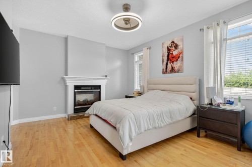 Light wood-finish flooring complements the neutral wall tones - 34 Valleyview Ridge, Fort Saskatchewan, AB - Indoor Photo Showing Bedroom
