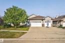 Exterior featuring a stone and siding facade, an attached two-car garage, and a concrete driveway - 34 Valleyview Ridge, Fort Saskatchewan, AB  - Outdoor With Facade 