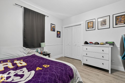 Bedroom featuring light wood-finish flooring and white walls with wainscoting - 34 Valleyview Ridge, Fort Saskatchewan, AB - Indoor Photo Showing Bedroom