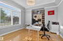 Bright room featuring hardwood flooring, a large window with white blinds, a tray ceiling, and a prominent accent wall with horizontal wood plank paneling - 34 Valleyview Ridge, Fort Saskatchewan, AB  - Indoor Photo Showing Office 
