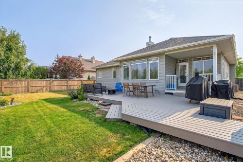 Expansive backyard featuring a composite deck, manicured lawn, and privacy fencing - 34 Valleyview Ridge, Fort Saskatchewan, AB - Outdoor With Deck Patio Veranda