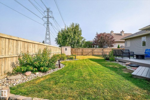 Expansive backyard featuring a manicured lawn, a raised composite deck, and a full perimeter wood fence - 34 Valleyview Ridge, Fort Saskatchewan, AB - Outdoor