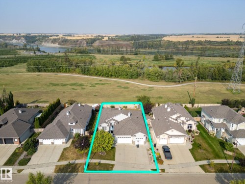 Single-story residence featuring light-colored siding and a dark-toned shingle roof - 34 Valleyview Ridge, Fort Saskatchewan, AB - Outdoor With View