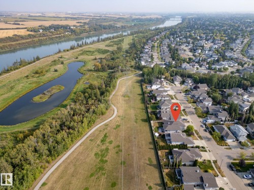 Aerial perspective showcasing a residential development bordering a natural landscape - 34 Valleyview Ridge, Fort Saskatchewan, AB - Outdoor With Body Of Water With View