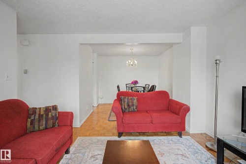 Living area featuring light-colored walls and wood flooring - 6F Castle Terrace, Edmonton, AB - Indoor Photo Showing Living Room