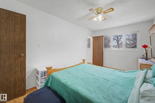 The room features white walls, a multi-paned window, and a ceiling fan with integrated lighting - 6F Castle Terrace, Edmonton, AB - Indoor Photo Showing Bedroom