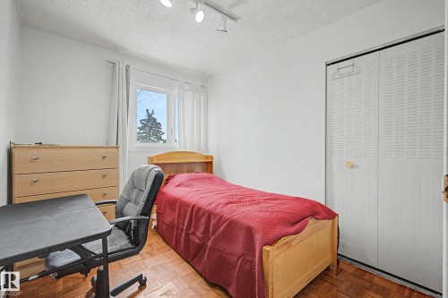 This room features a window providing natural light, white walls, and parquet flooring - 6F Castle Terrace, Edmonton, AB - Indoor