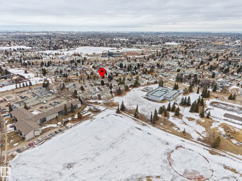 Aerial view showcasing the property's location within a developed community, surrounded by other residential buildings and open land - 6F Castle Terrace, Edmonton, AB - Outdoor With View