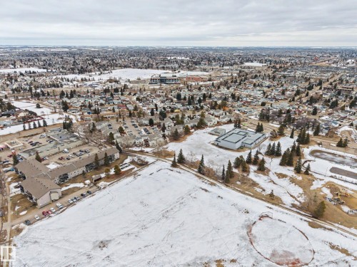 Aerial view of the neighborhood showcasing residential areas, open fields, and trees - 6F Castle Terrace, Edmonton, AB - Outdoor With View