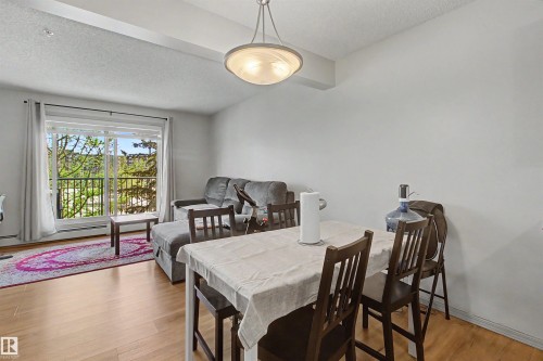 Open-concept living space with wood-finish flooring - 204 309 Clareview Station Drive, Edmonton, AB - Indoor Photo Showing Dining Room