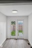 Dual French doors opening to an outdoor area with a wooden fence - 13833 24 Street W, Edmonton, AB  - Indoor Photo Showing Other Room 