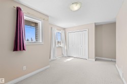 Carpeted room with neutral wall tones and white baseboards - 