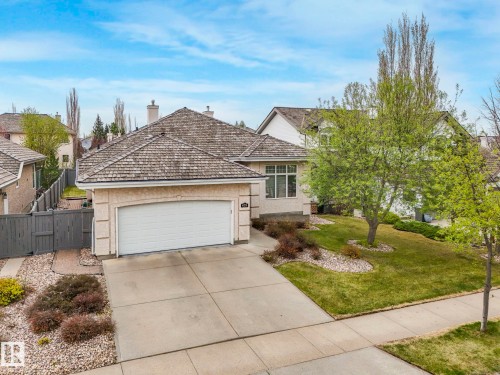 Neutral-toned stucco exterior with a cedar shake roof - 879 Drysdale Run Run, Edmonton, AB - Outdoor