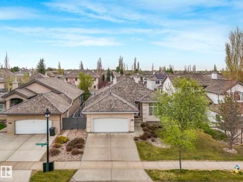 Single-story residence featuring a two-car garage, concrete driveway, and a shingle roof - 879 Drysdale Run Run, Edmonton, AB - Outdoor With Facade