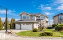 Two-story residence featuring light-toned siding and a stone-clad lower level - 3412 Macneil Link, Edmonton, AB 