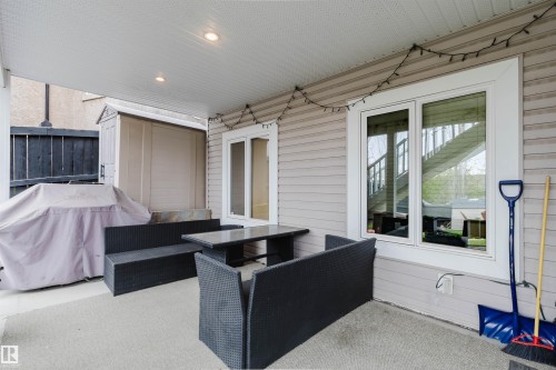 Covered patio with recessed lighting, vinyl siding, and a white-framed window - 3412 Macneil Link, Edmonton, AB 