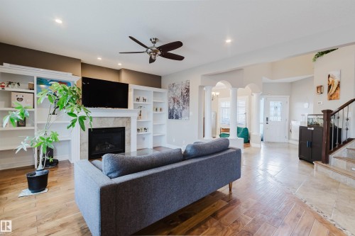 Spacious living area featuring wood-finish flooring, a ceiling fan, and recessed lighting - 3412 Macneil Link, Edmonton, AB 