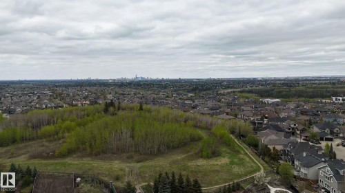 Expansive aerial perspective showcasing a residential area with a distant city skyline - 3412 Macneil Link, Edmonton, AB - Outdoor With View