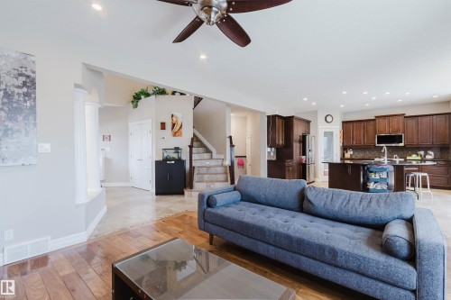 Open-concept living space featuring wood-finish flooring and recessed lighting - 3412 Macneil Link, Edmonton, AB 