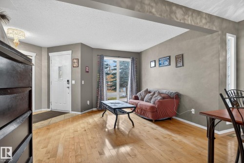 Hardwood-finish flooring extending through the living area, complemented by neutral wall tones - 3912 31 Street, Edmonton, AB 