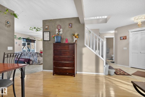Hardwood-style flooring extends through the main living area - 3912 31 Street, Edmonton, AB 