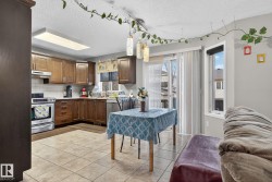 Kitchen featuring wood-finish cabinetry, stainless steel appliances, and a subway tile backsplash - 