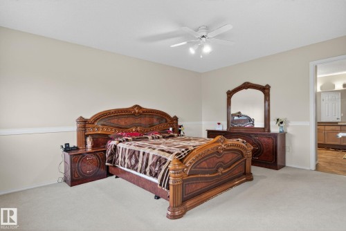 Spacious room featuring neutral wall tones, white baseboards, and light-toned carpeting - 3912 31 Street, Edmonton, AB 