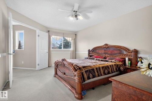 Bedroom featuring light neutral wall tones, white trim, and light-colored carpet flooring - 3912 31 Street, Edmonton, AB 