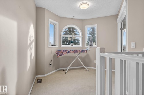 Inviting landing area with soft neutral wall tones and plush carpeting - 3912 31 Street, Edmonton, AB 